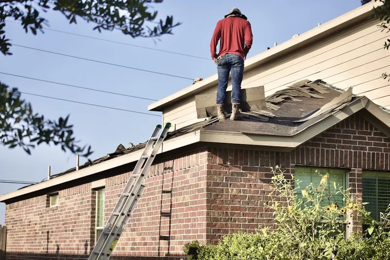 Professional roofer working on a residential roof in Singac